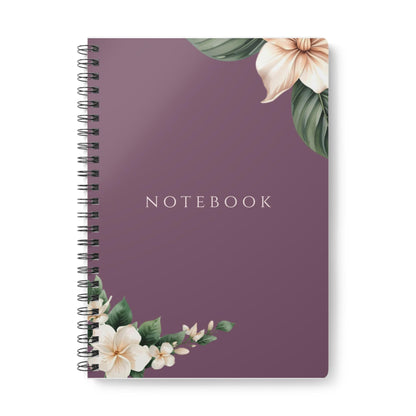 Close-up product photo of the Eternal Light A5 purple spiral notebook featuring white floral corner illustrations. The word NOTEBOOK is printed in white capital letters in the center.