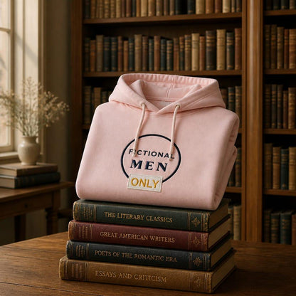 Pink book lover hoodie featuring the "Fictional Men Only" design, displayed on a stack of vintage books in a warm library setting. Cosy reading sweatshirt and thoughtful gift for romance readers and book enthusiasts.