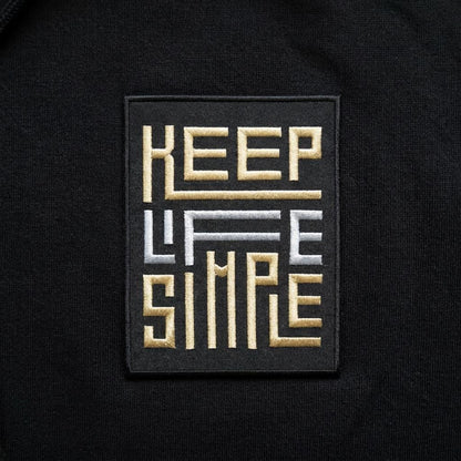 KEEP LIFE SIMPLE embroidered patch in metallic gold and silver.