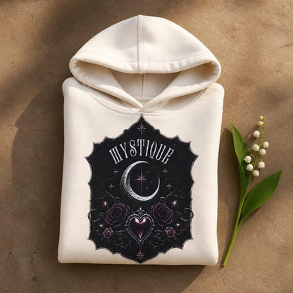 Gothic moon and roses tween hoodie in cream with dark romantic celestial artwork, neatly folded with a sprig of lily of the valley next to it.
