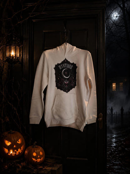 Mystique tween hoodie styled in a dark autumn scene with warm Halloween lighting.
