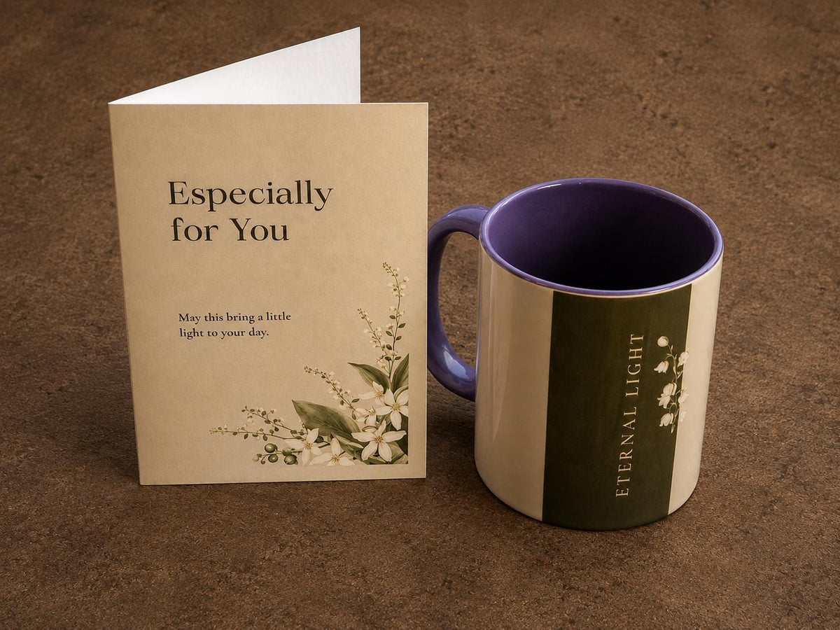 A minimalist photo of the Eternal Light signature mug and a luxury message card placed side-by-side on a rustic brown concrete floor.