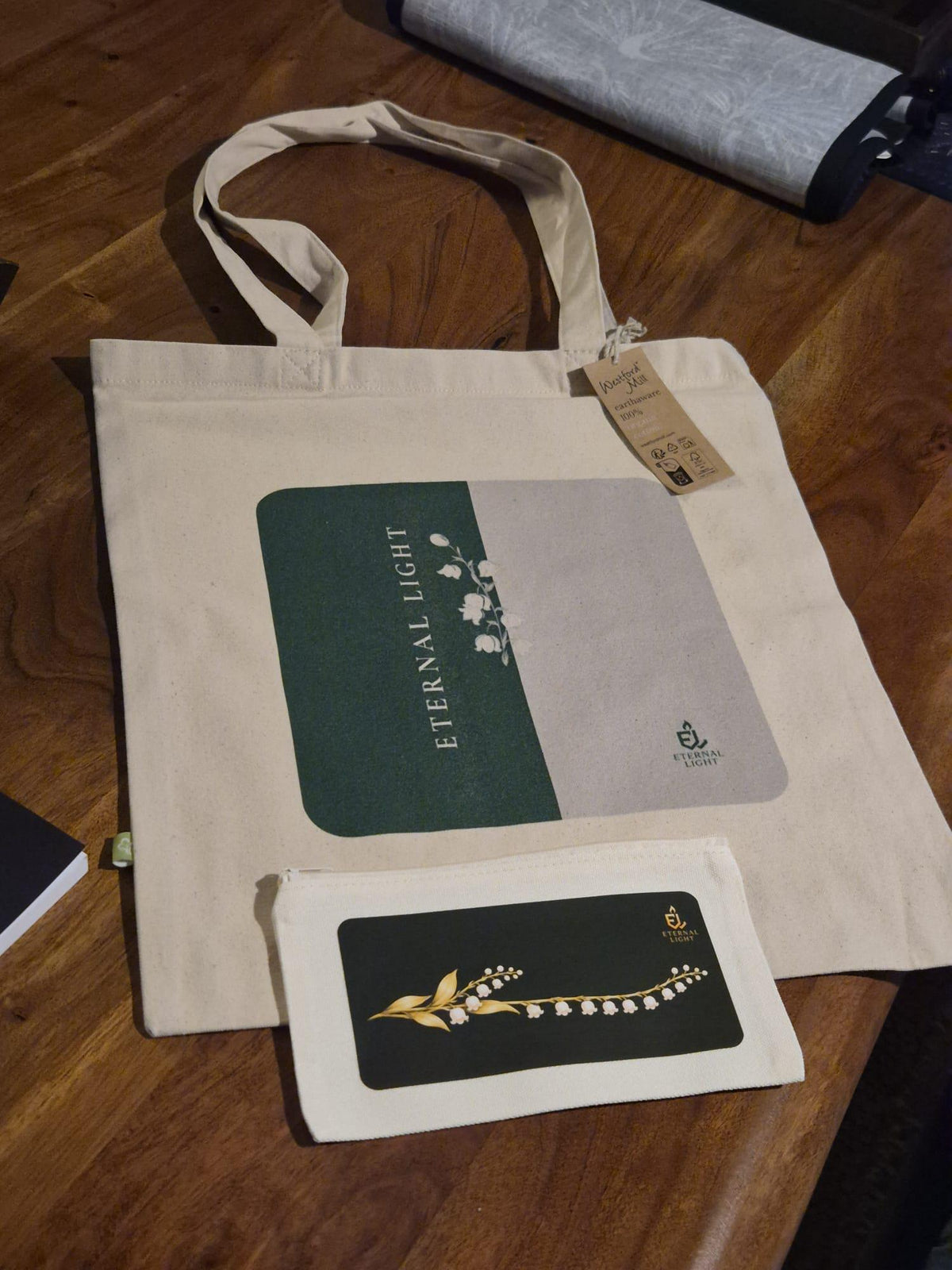 Lily of the Valley organic canvas tote bag paired with the matching Eternal Light compact zippered pouch.