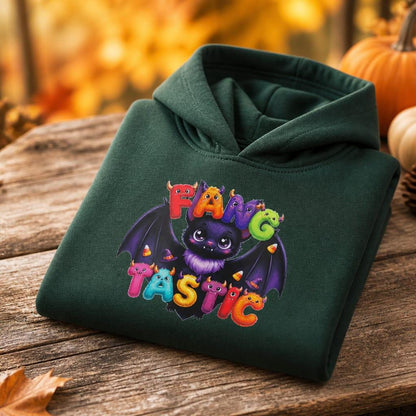 Kids Fangtastic monster hoodie neatly folded, and styled with golden autumn leaves and pumpkins for Halloween.
