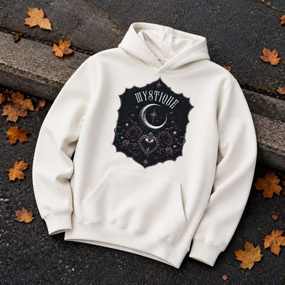 Cream organic cotton tween hoodie with dramatic black and plum gothic design, lying on a kerb with autumn leaves around it.