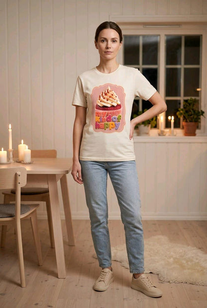 Woman wearing My Kind of Happy ecru graphic T shirt with jeans in a warm cosy home setting.