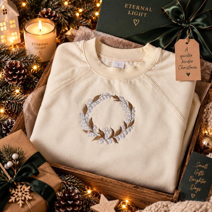 Ecru Lily of the Valley wreath embroidered sweatshirt styled in a cosy winter setting.